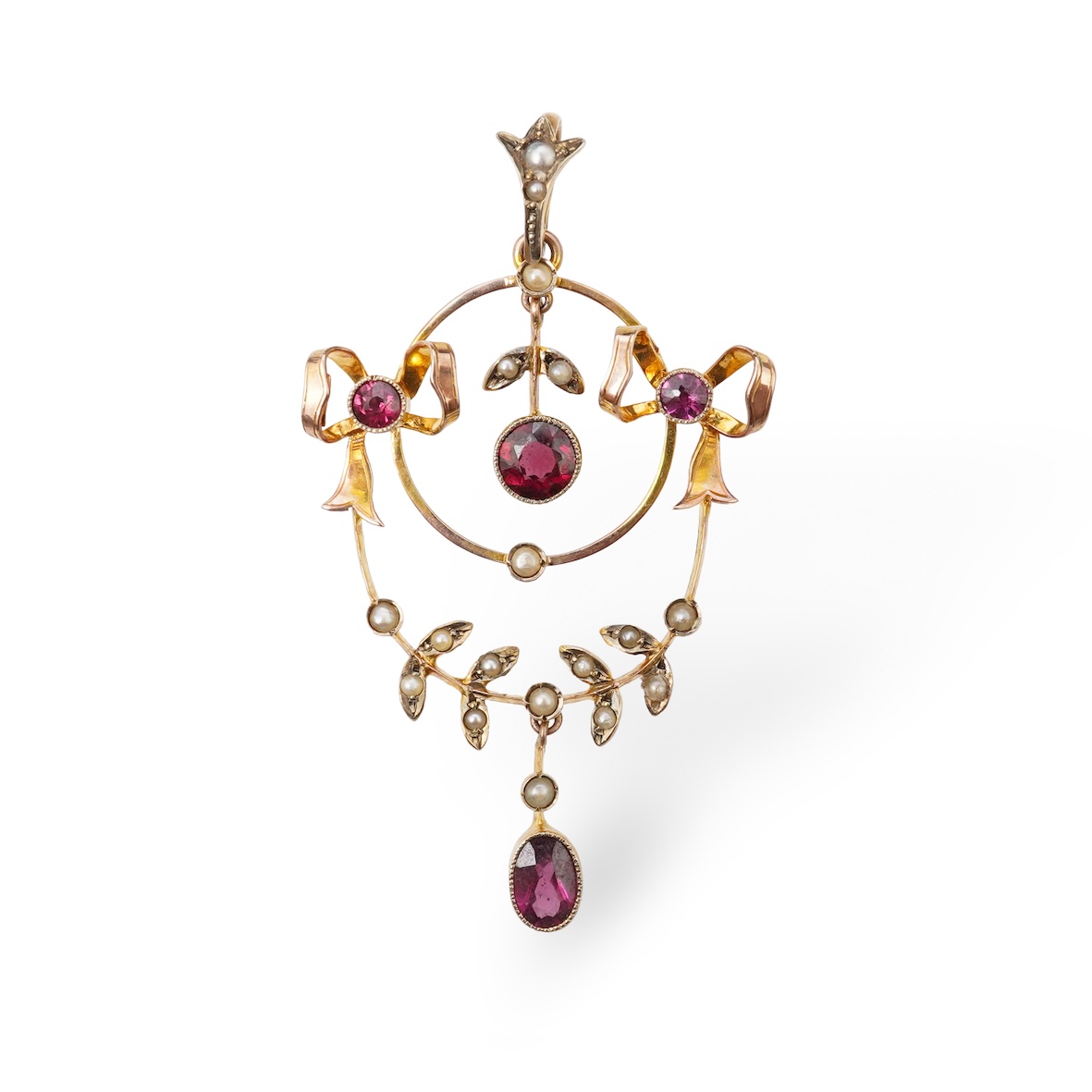 An Edwardian garnet and seed pearl pendant, early 20th century, of foliate design with ribbon bow motifs, set with circular-cut and oval garnets and seed pearls, mounted in gold, length 5.2cm, stamped 9CT, gross weight a
